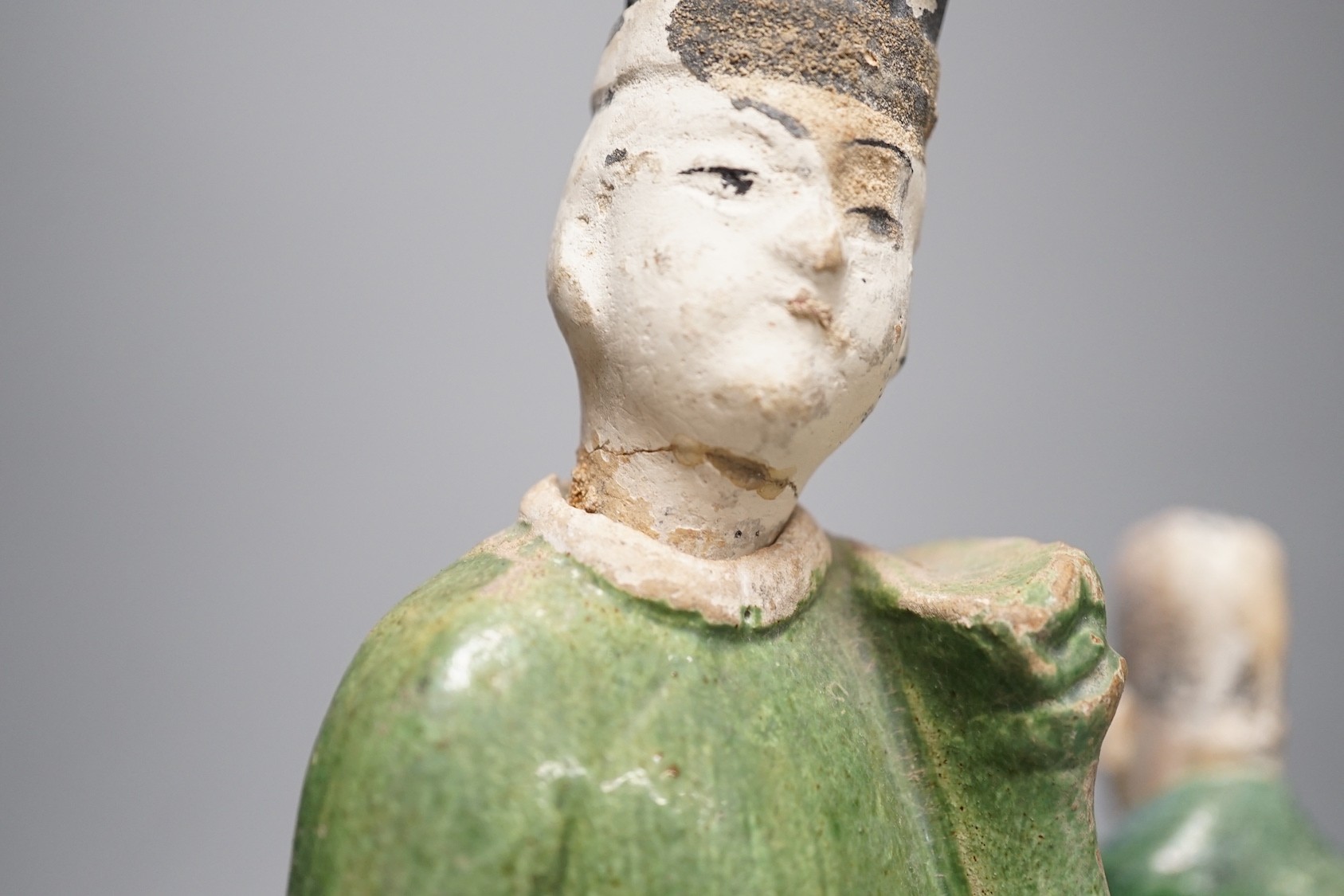 Three Chinese Ming pottery figures of attendants, 28cm tall